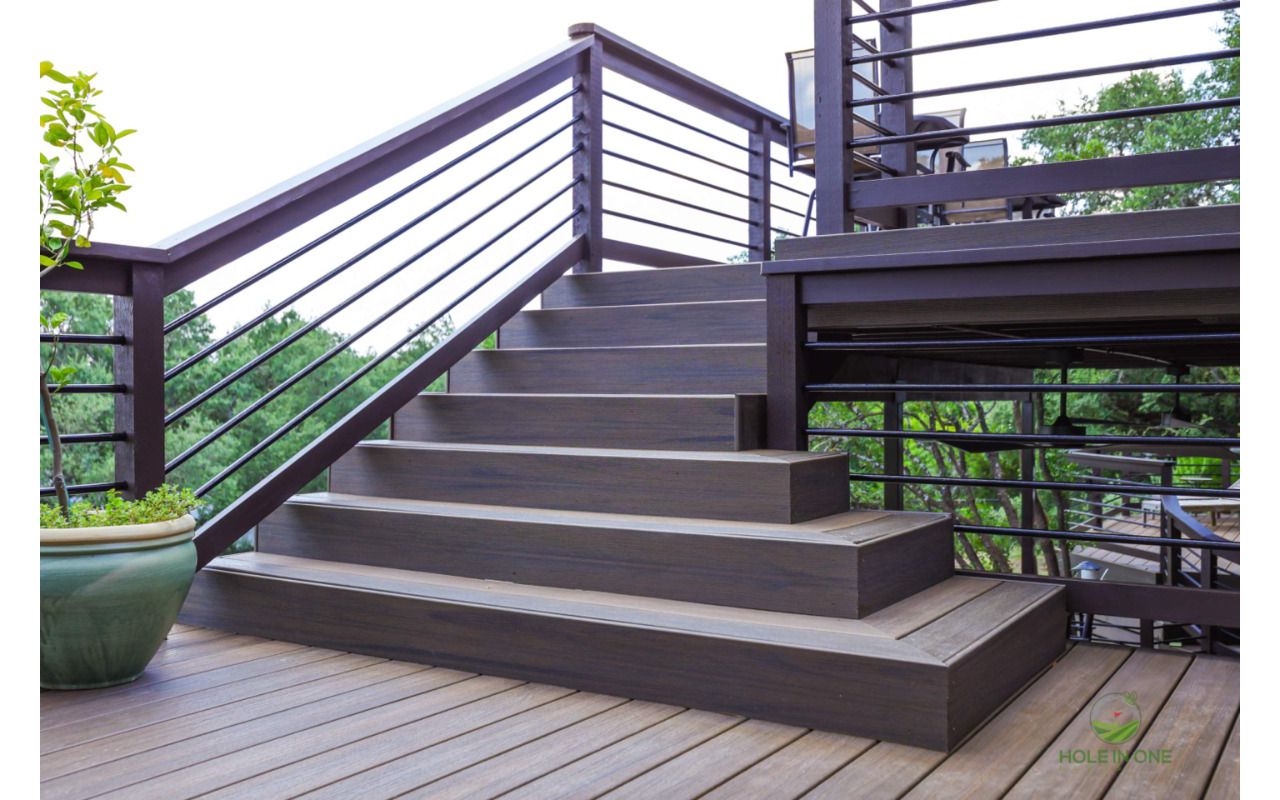 Trex composite stairs with horizontal metal railing leading to a second-story deck