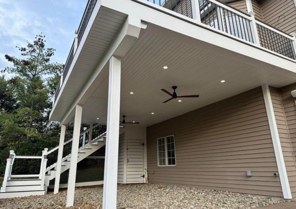 Elevated Trex composite deck with under-deck ceiling system. Adds usable covered space below while maintaining a clean, modern structure.