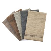 A set of six rectangular composite material samples featuring wood-like textures. The samples are displayed fanned out, showcasing a range of neutral tones including beige, gray, and brown. The textures mimic natural wood grain patterns, ideal for construction or design projects.
