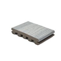 A single piece of gray composite decking board is displayed against a white background. The board features a realistic wood grain texture on the surface and a hollow core structure underneath. The sample is shown at an angle to highlight both the top texture and the internal design. No visible text or numbers are present on the board.