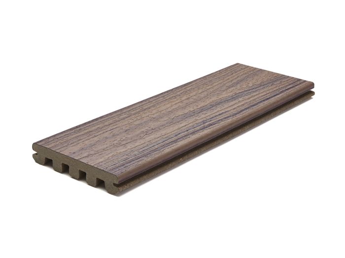 A single composite decking board is displayed against a white background. The board features a realistic wood grain pattern and a grooved edge, suggesting suitability for outdoor flooring or decking installations. The color palette includes natural brown and taupe tones, and the board's hollow core construction is visible from the side.