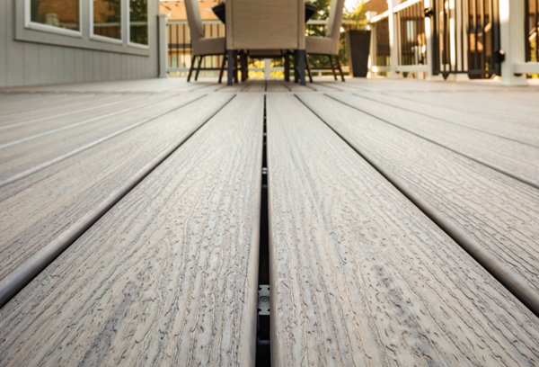 A close up detailed shot of the spacing of deck boards with Trex universal hidden fasteners shown through the slats of the boards. 