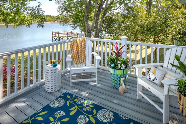 Trex Transcend railing with square composite balusters installed on a deck overlooking the water