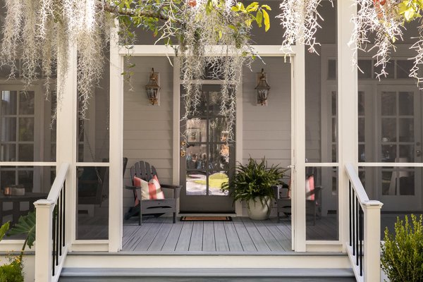 Screened in porch with decking in Trex Foggy Wharf with two Adirondack chairs looking out on the yard