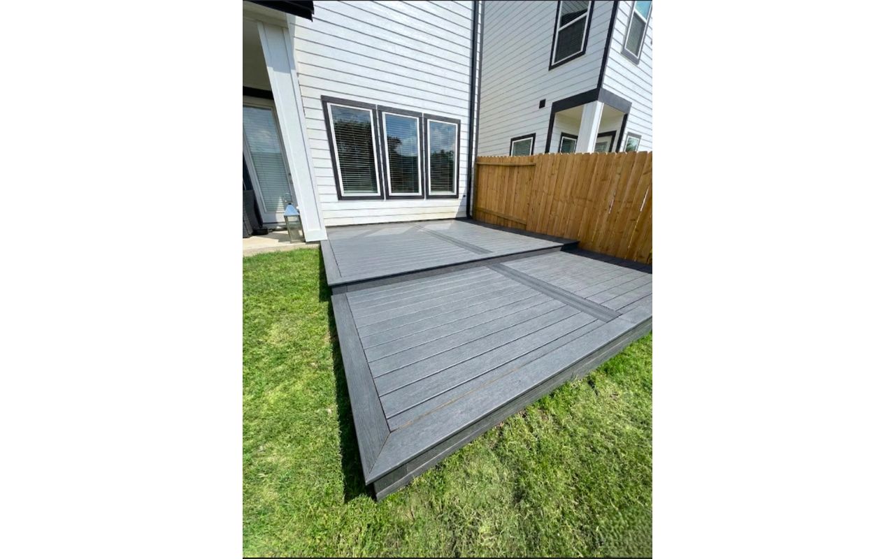 Multi-level gray composite deck in Houston, Texas. Designed to create defined outdoor zones for seating, dining, and relaxing.