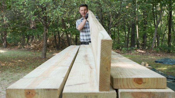 Person crowning a joist by looking down the length of it.