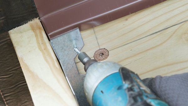 attaching the side joist to the ledger board using an angle bracket