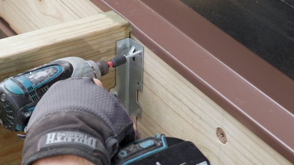 screwing in joist hanger into ledger board