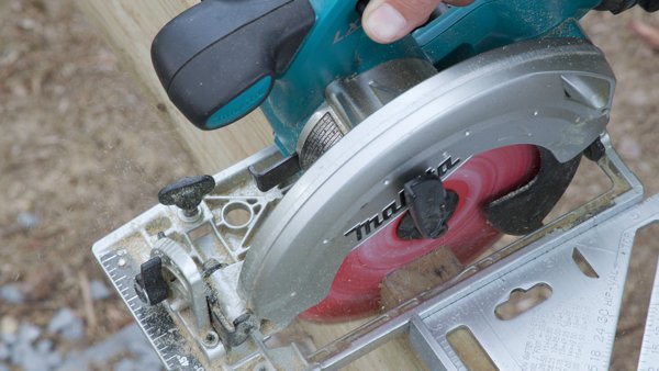 using a speed square to align circular saw cut on joists