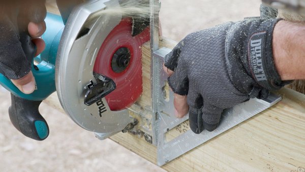 using a speed square to align circular saw cut in downward motion on joist