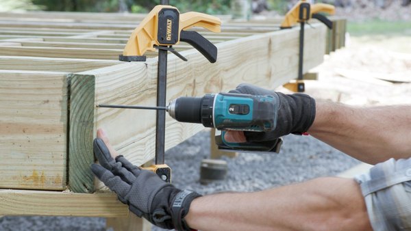 person predrilling joists
