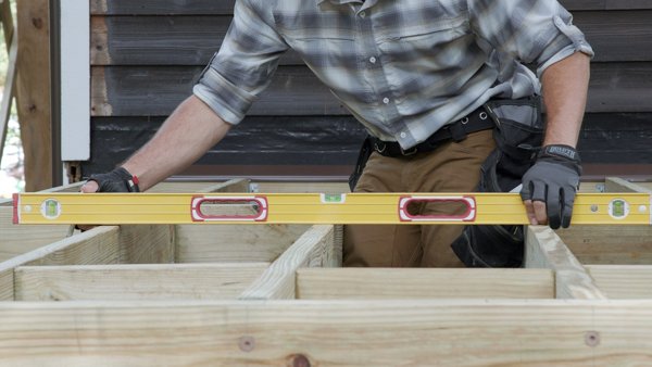 person using level to level the joists