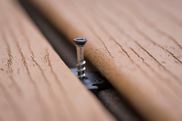 A closeup of a Trex Hidden Fastener screw and tool to install a Trex deck. 