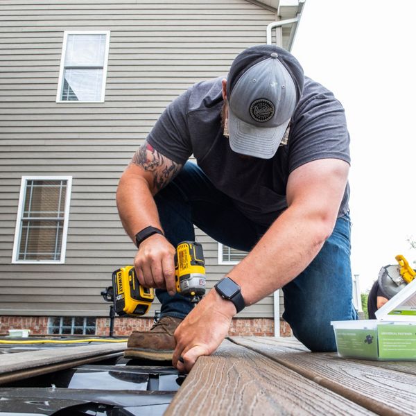 Two contractors building a Trex deck.