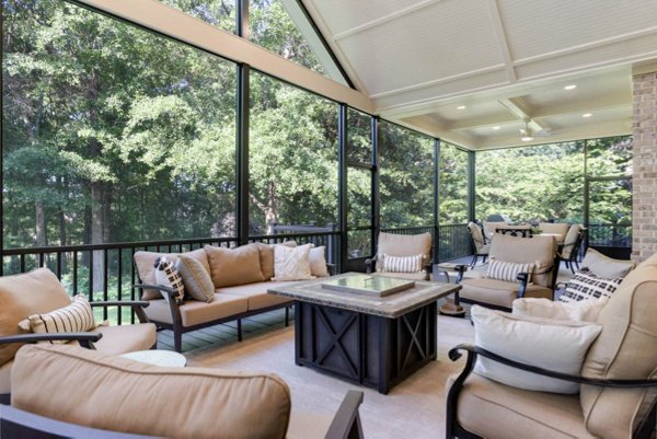 Screened in porch with decking in Trex Foggy Wharf with two Adirondack chairs looking out on the yard