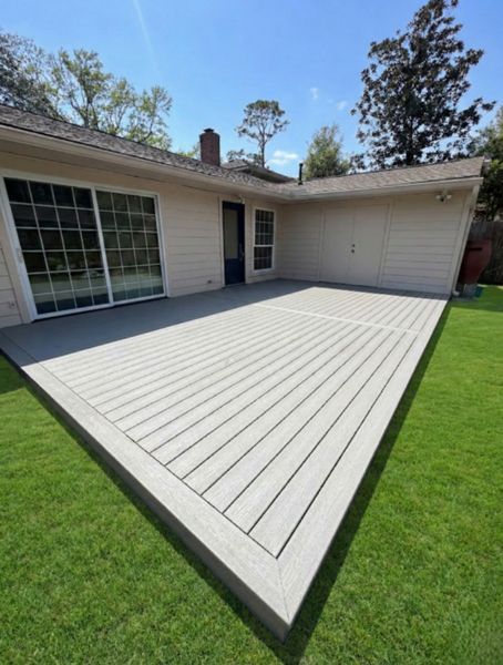 Light gray Trex composite deck, ground-level installation. Minimalist design with a clean finish, perfect for low-maintenance outdoor living.