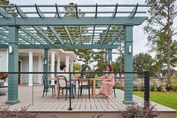 HGTV Dream Home 2025 photo with a couple on their deck sitting at table enjoying a conversation.