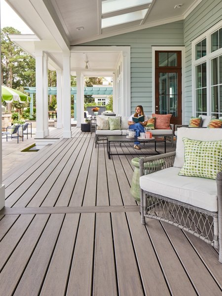 HGTV Dream Home 2025 photo with a woman sitting in a deck chair enjoying some coffee with nice low panned view of the deck. 