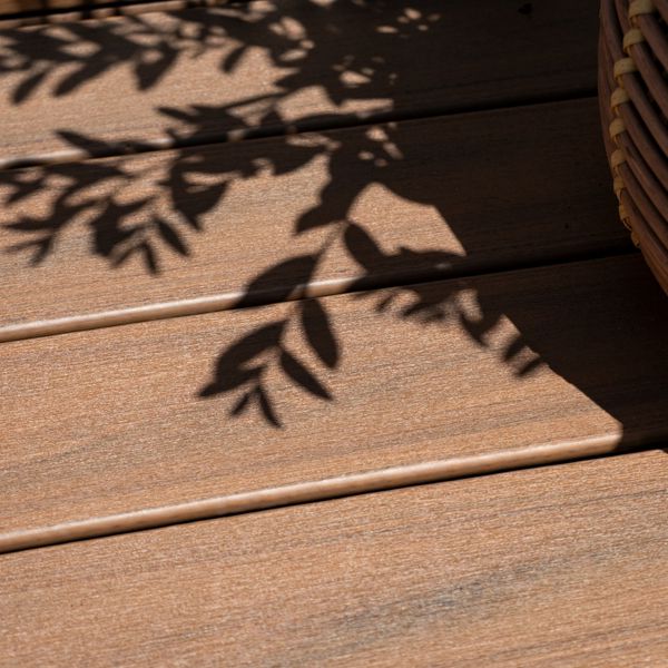 Trex Transcend Lineage decking in Jasper color in a backyard with plants