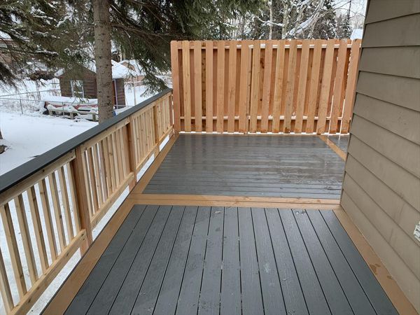 Trex Enhanced clam shell with beach dune boarder & cedar rail/privacy fence.