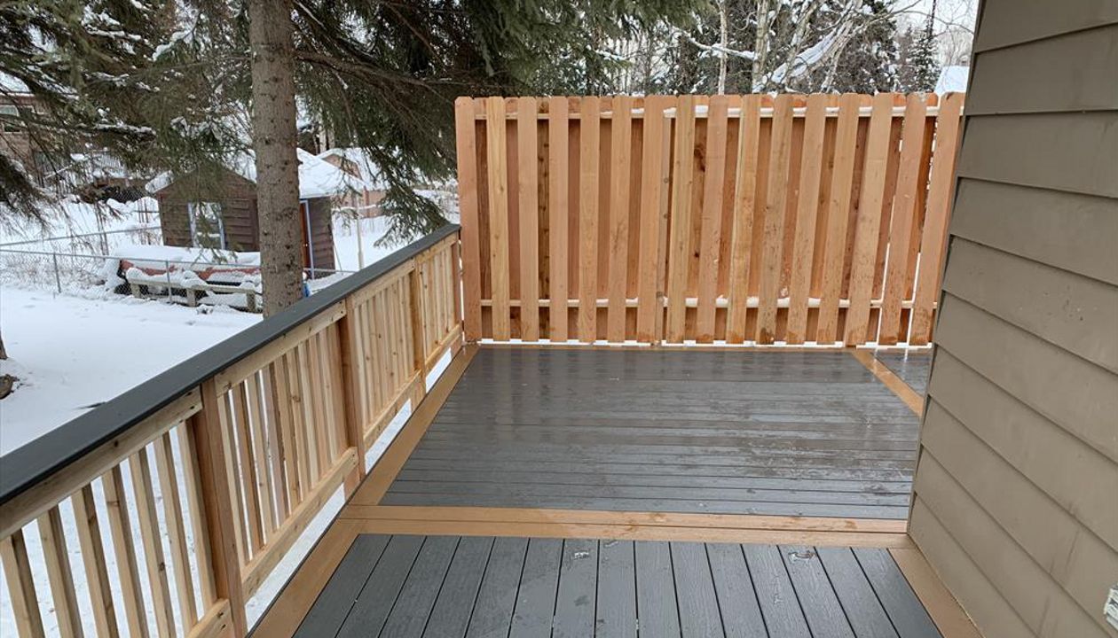 Trex Enhanced clam shell with beach dune boarder & cedar rail/privacy fence.