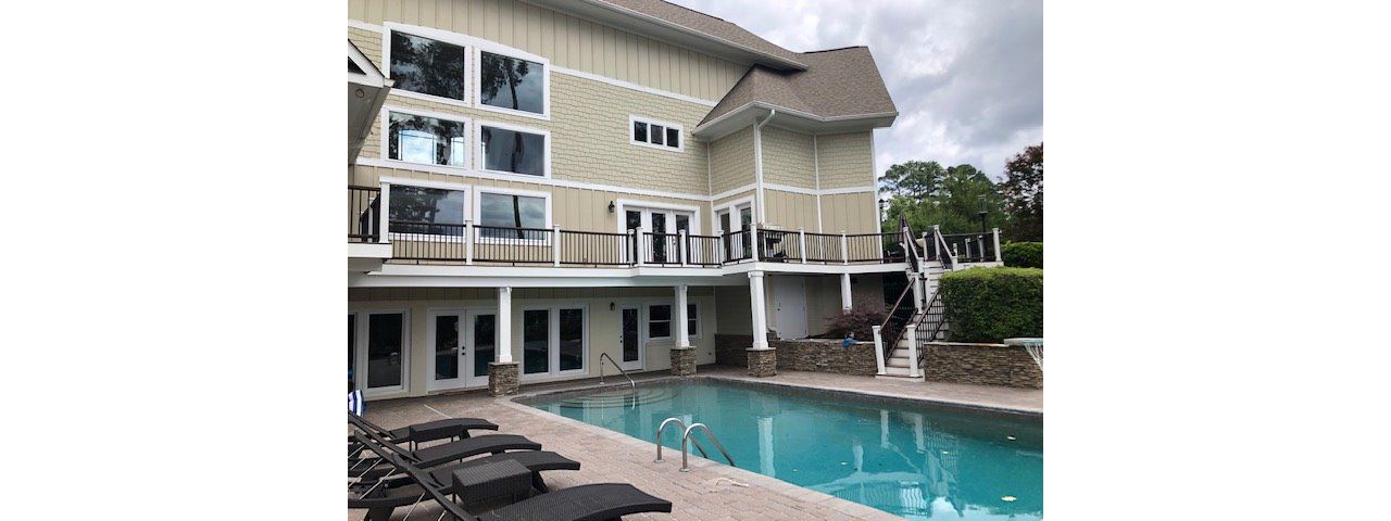 Breath-taking new Trex Enhance Toasted Sand deck with Transcend Vintage Lantern railing in Cary, NC