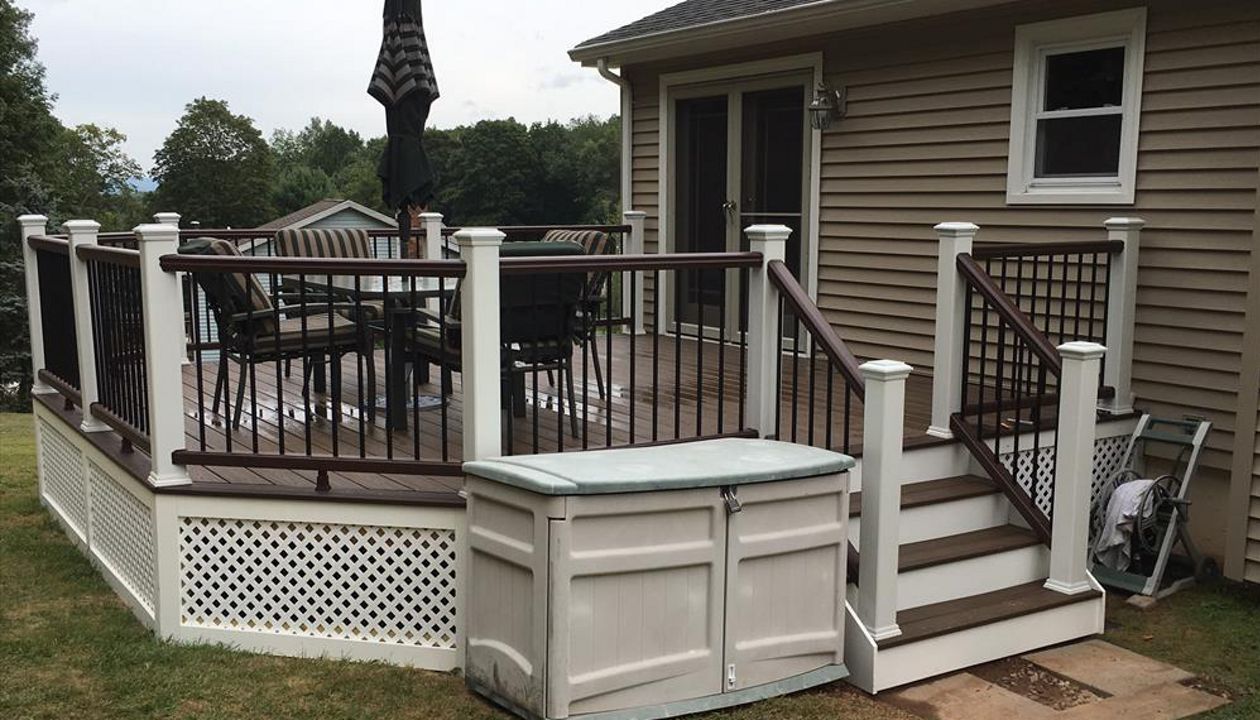 Trex Transcend project in Middletown, CT.  Spiced Rum field featuring a Vintage Lantern border.  - Railings are Trex Transend in Vintage Lantern with black aluminum balusters.