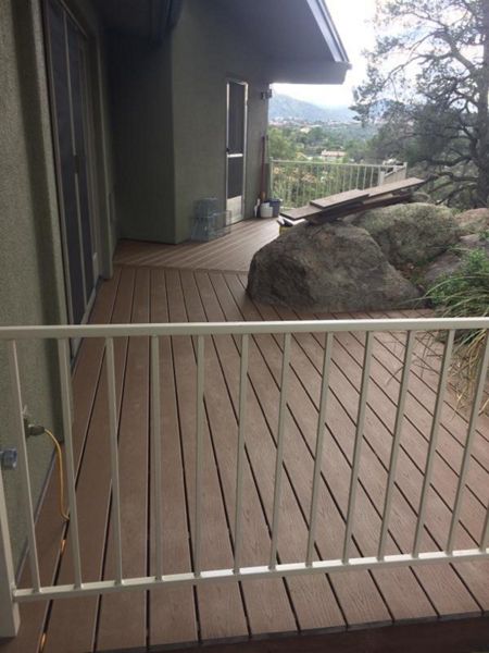 Prescott AZ. Tiki Torch with groove, hidden clips. Trex joist tape. Scribed around boulders.