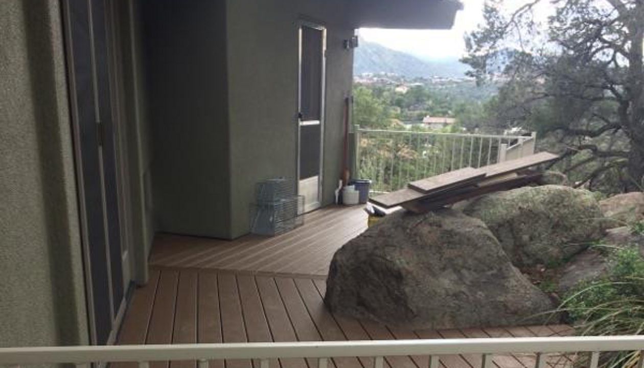 Prescott AZ. Tiki Torch with groove, hidden clips. Trex joist tape. Scribed around boulders.