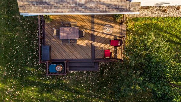 This deck uses Trex Transcend decking and railing and features a compass rose inlay.