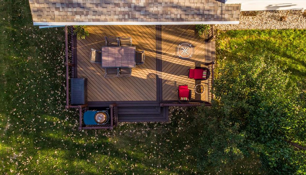 This deck uses Trex Transcend decking and railing and features a compass rose inlay.