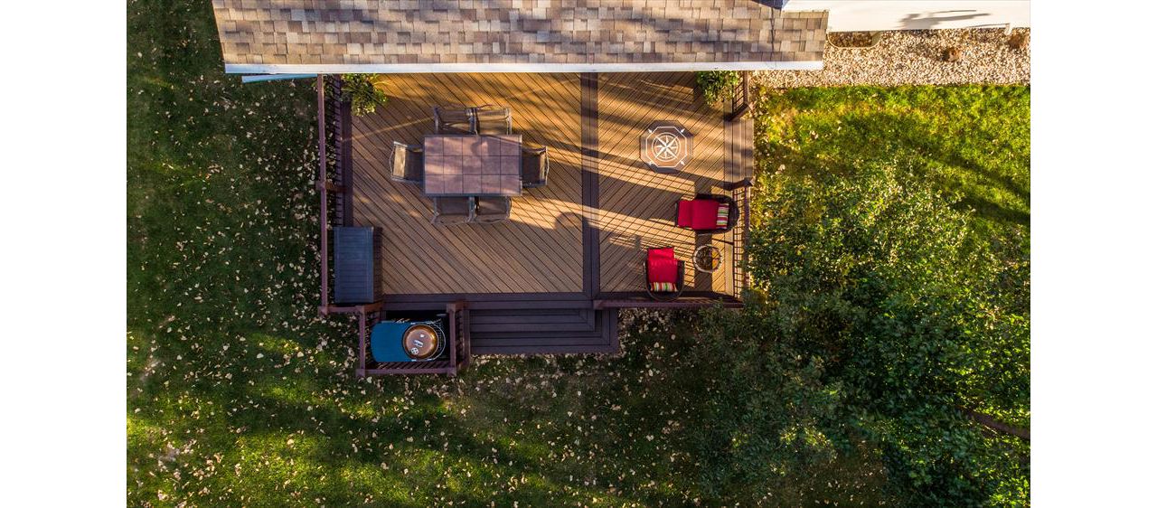 This deck uses Trex Transcend decking and railing and features a compass rose inlay.