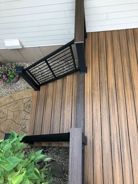Trex/Transcend/Composite Decking and Trex/Transcend/Spiced Rum Fascia and Border with Trex/Signature/Rod-Rail (all black) and Trex/Transcend/Spiced Rum Composite Decking Cocktail Rail