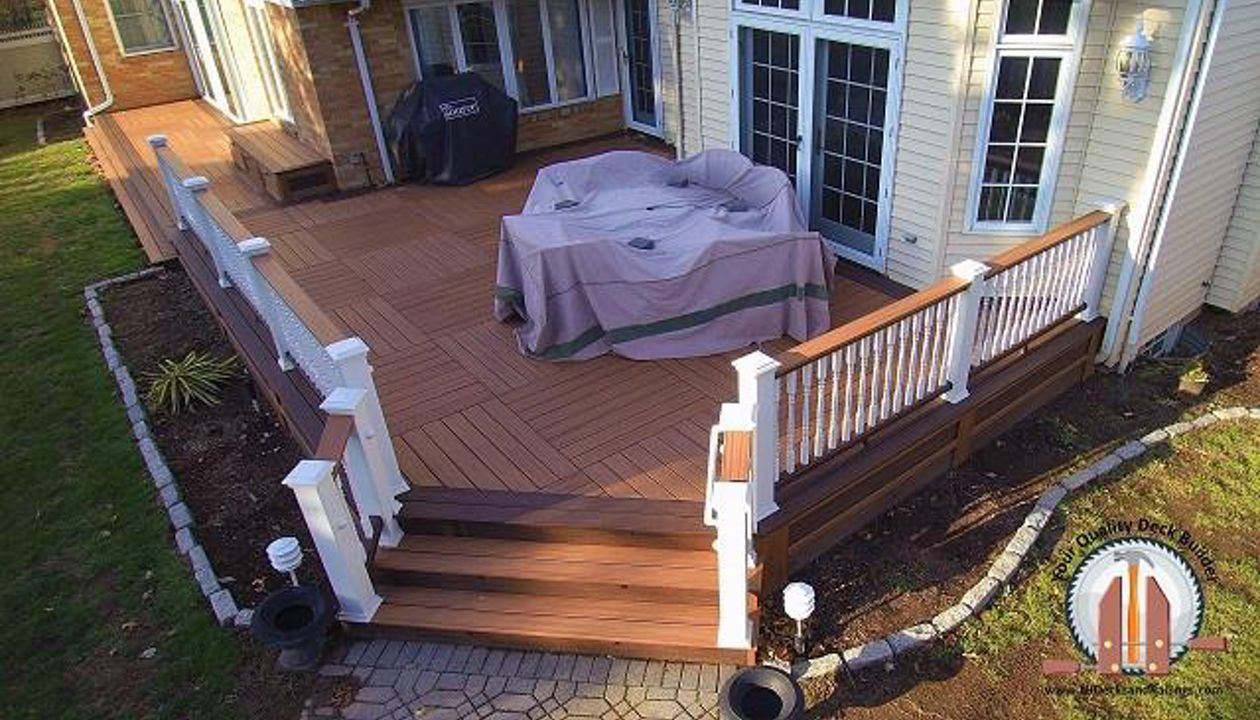 Custom deck with a Tiki Torch parquet Body with Lava Rock border in Bergenfield, NJ