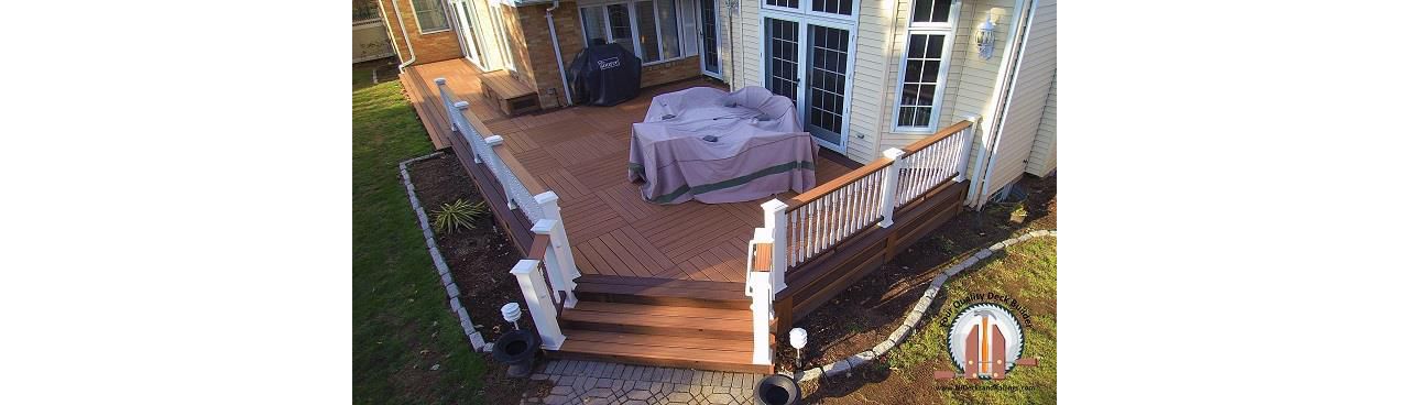 Custom deck with a Tiki Torch parquet Body with Lava Rock border in Bergenfield, NJ
