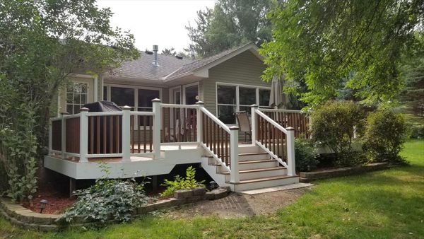 Trex Transcend Tropics Tiki Torch deck boards with Transcend crown railing (classic white rails with tree house balusters), Classic white fascia serving the Twin Cites, Hastings, Woodbury, Egan, Edina, Minneapolis, Lake of the Isles