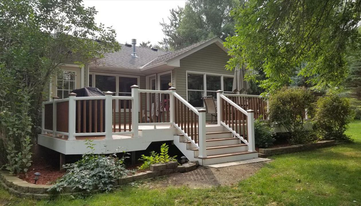 Trex Transcend Tropics Tiki Torch deck boards with Transcend crown railing (classic white rails with tree house balusters), Classic white fascia serving the Twin Cites, Hastings, Woodbury, Egan, Edina, Minneapolis, Lake of the Isles