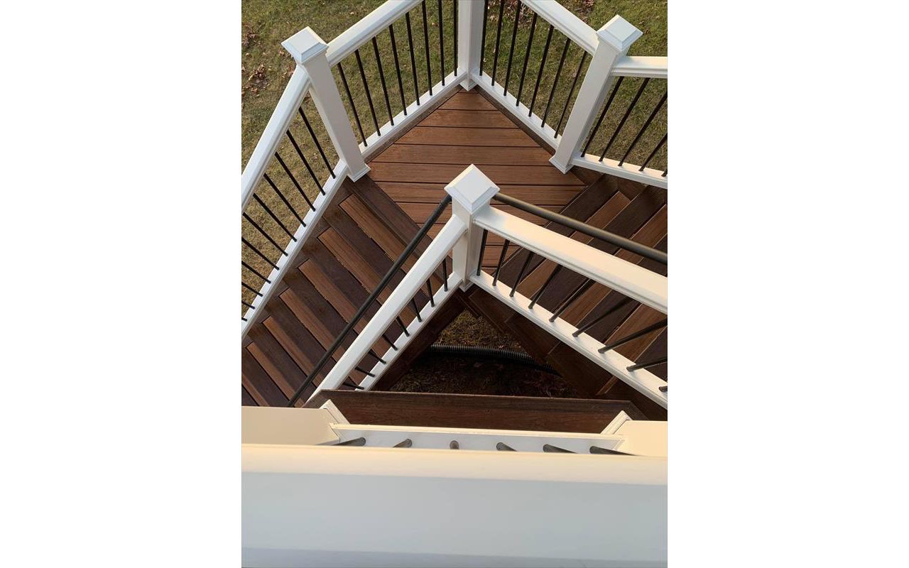 Trex Tiki Torch decking, Trex Lava Rock Border and Fascia,  Two tone stairs, White Trex Transcend Railing,  Waterford Michigan Oakland County Wright Way Contractors