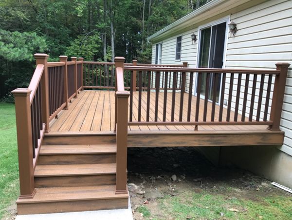 1 of 2 - 12x16 deck with Havana Gold Trex Transcend with all hidden fasteners. Trex Transcend railing color of Treehouse with Vintage Lantern balusters.