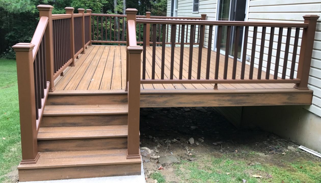 1 of 2 - 12x16 deck with Havana Gold Trex Transcend with all hidden fasteners. Trex Transcend railing color of Treehouse with Vintage Lantern balusters.