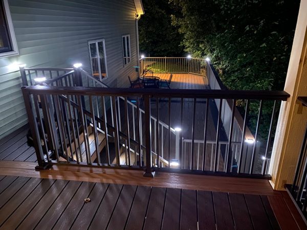 Two-Tone Low-Maintenance Trex Transcend Composite Deck with Black, Aluminum Railing and LED Lighting for Safety and Ambiance in the Rochester, MN Area built by Schmidt Carpentry, LLC