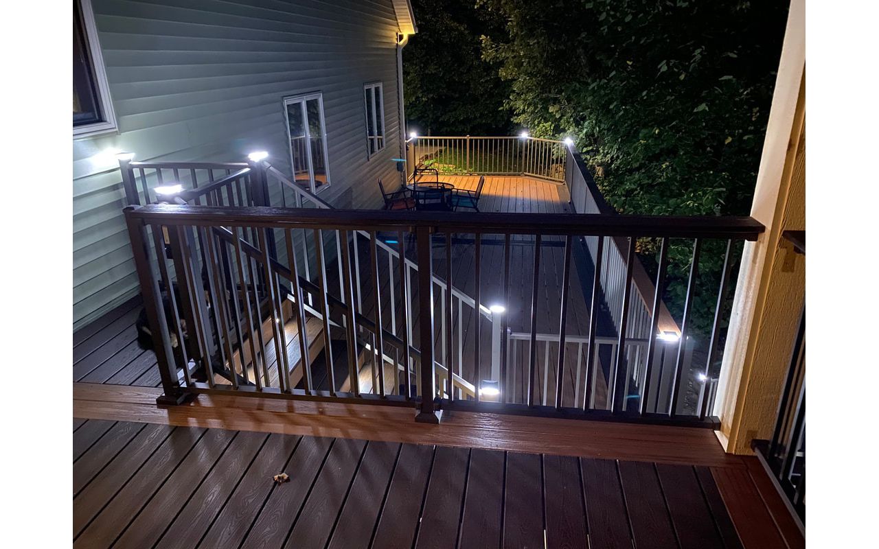 Two-Tone Low-Maintenance Trex Transcend Composite Deck with Black, Aluminum Railing and LED Lighting for Safety and Ambiance in the Rochester, MN Area built by Schmidt Carpentry, LLC