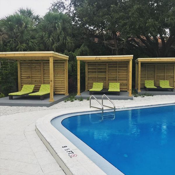 Three matching cabanas line the side of this transformed pool area at a South Tampa apartment complex.