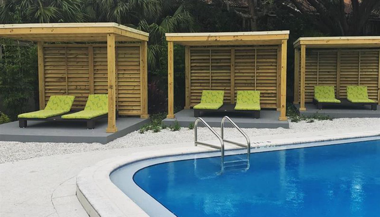 Three matching cabanas line the side of this transformed pool area at a South Tampa apartment complex.