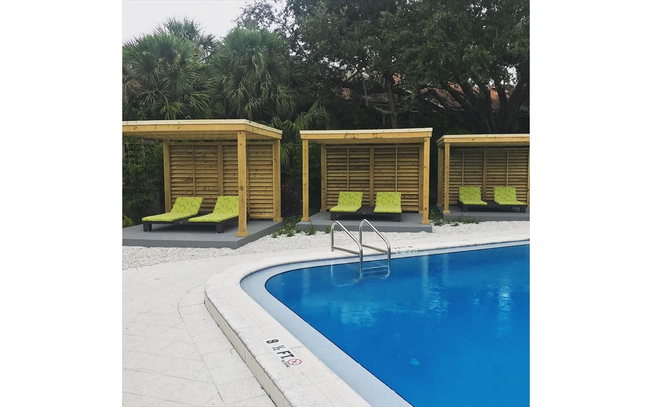 Three matching cabanas line the side of this transformed pool area at a South Tampa apartment complex.