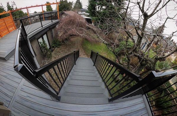 Island Mist field, Clamshell bordering. Aluminum railings, accented with stained cedar privacy screens and arbor system.