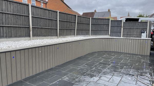 In the beautiful village of olney we we tasked with hiding the tatty old brick wall so we clad it with Trex transcend composite decking in the popular gravel path colour what a clean fresh look, stunning.