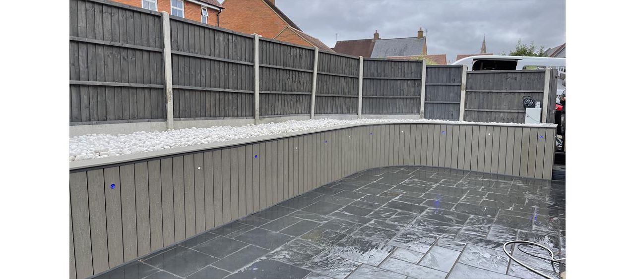 In the beautiful village of olney we we tasked with hiding the tatty old brick wall so we clad it with Trex transcend composite decking in the popular gravel path colour what a clean fresh look, stunning.