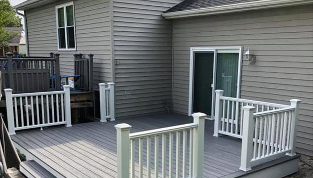 This deck features all white Trex transcend railing and fascia. It consists of Trex Transcend island mist decking