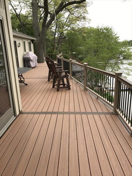 Deck on Middle Straits Lake in West Bloomfield, MI., constructed out of Trex Transcend Tropical decking in Tiki Torch / Spiced Rum; complimented by Trex Rope Swing railing w/ black balusters.